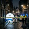 Crime scene investigation on Brick Lane with police and forensic team working